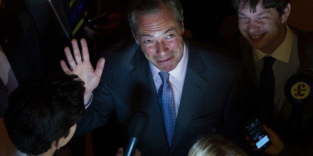 UK Independence Party (UKIP) leader Nigel Farage (C) waves as he speaks to the media at the Southampton Guildhall announcement of the South East England region results from the European Parliament elections in Southampton, southern England, on May 25, 2014. Results starting rolling in the European Parliament elections with all eyes on potential gains by Europe's increasingly popular anti-EU parties. Farage, leader of the eurosceptic UKIP, on May 25 said his party was on course to cause a politic