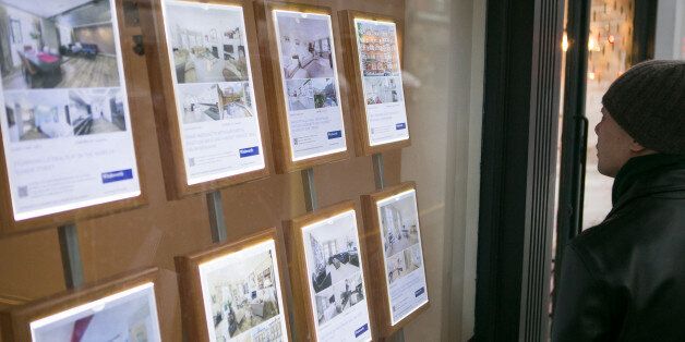 File photo dated 4/12/2014 of a member of the public looks in the window of an estate agents in South Kensington, London. Prime Minister David Cameron will today launch a scheme offering 100,000 first-time buyers new homes with a 20\% discount as part of the Government's drive to help people onto the housing ladder.