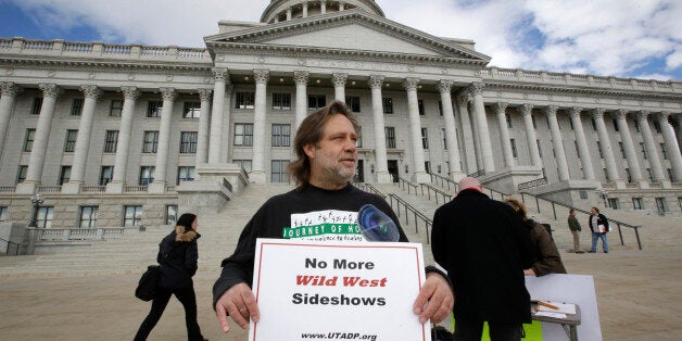 FILE - In this Jan. 27, 2015, file photo, Randy Gardner of Salt Lake City, the older brother of Ronnie Lee Gardner, the last inmate to be killed by firing squad in Utah in 2010, protests with a group opposed to capital punishment plans over one lawmaker's plan to resurrect the use of firing squads, outside the Utah State Capitol, in Salt Lake City. A controversial proposal that resurrects Utah's use of firing squads to carry out executions has advanced in the state legislature by a handful of votes. (AP Photo/Rick Bowmer, File)