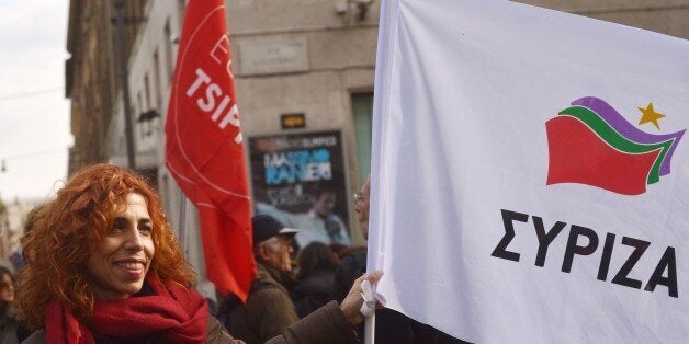 A woman shows a flag of Greek party Syriza on February 14, 2015 in Rome during a demonstration to support new hard-left Greek Prime Minister Alexis Tsipras (Syriza) during his talks in Brussels and to protest against austerity. Greek and EU officials met for talks today ahead of a high-stakes show-down over Athens' demands for a radical restructuring of its massive international bailout programme. 'It is not a negotiation but an exchange of views to better understand each other's position,' an