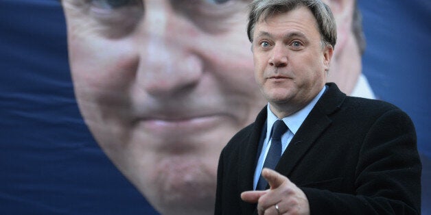 Shadow chancellor Ed Balls unveils Labour's new poster marking the government's reduction in the 50p tax rate, in London.