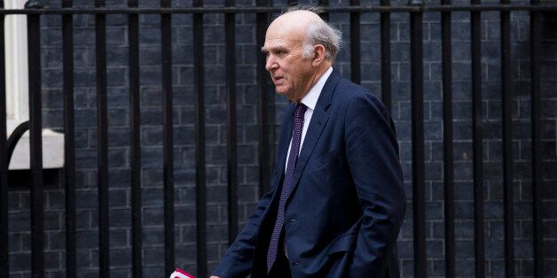 Business Secretary Vince Cable walks through Downing Street