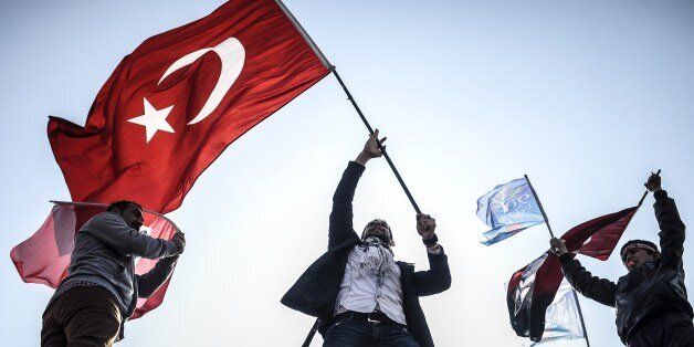 Supporters of Turkey's main opposition Republican People's Party (CHP) wave Turkish and party flags during an election rally at Kadikoy in Istanbul on March 29, 2014. Turkey gears up for local elections on March 30 ahead of a presidential vote in six months and parliamentary polls next year. Turkey's Premier Recep Tayyip Erdogan and his Islamic-leaning party, after over a decade in power, face the first electoral test following months of political turmoil, with mass street protests and a corruption scandal spread via Twitter, Facebook and YouTube. Amid an atmosphere of distrust ahead of tomorow's election with over 50 million eligible voters, the CHP and tens of thousands of citizen volunteers plan to monitor the ballot count. AFP PHOTO / BULENT KILIC (Photo credit should read BULENT KILIC/AFP/Getty Images)