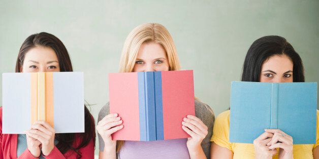 Women hiding behind books