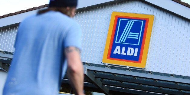 A customer pushes a shopping cart towards the entrance of an Aldi discount supermarket, operated by Aldi Stores Ltd., in Chelmsford, U.K., on Tuesday, Oct. 7, 2014. Wm Morrison Supermarkets Plc stepped up the battle for U.K. supermarket customers by becoming the first of Britain's four biggest grocers to match its prices to those of discounters Aldi and Lidl Ltd. Photographer: Chris Ratcliffe/Bloomberg via Getty Images