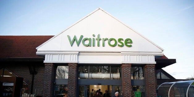 Customers push shopping carts through the entrance of a Waitrose Ltd. supermarket in the Hove district of Brighton, U.K., on Tuesday, Jan. 27, 2015. Britain has outperformed its neighbors, with the fastest economic growth in the Group of Seven industrialized nations. Photographer: Simon Dawson/Bloomberg via Getty Images