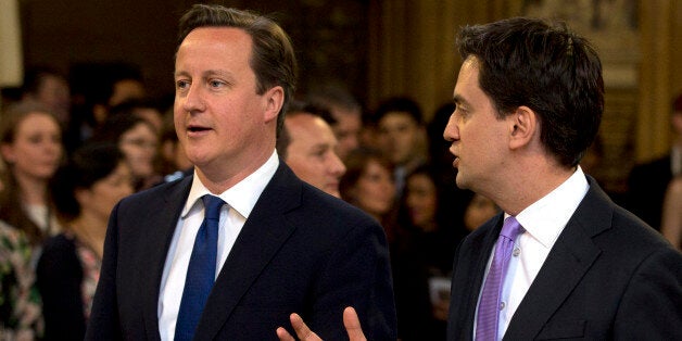 Britain's Prime Minister David Cameron, left, with the Leader of the Opposition Ed Miliband walk from the House of Commons through the central lobby towards the House of Lords to hear Britain's Queen Elizabeth II deliver the Queen's Speech to Parliament at the Place of Westminster in London Wednesday, May 8, 2013. The Queen's Speech outlines her governments legislative plans for the forthcoming parliamentary year, that her lawmakers will debate vote and enact on.(AP Photo/Alastair Grant, Pool)