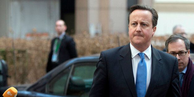British Prime Minister David Cameron, center, arrives for an EU summit in Brussels on Thursday, Feb. 12, 2015. EU leaders meet for a one-day summit on Thursday to discuss, among other issues, European banks and the situation in Ukraine.(AP Photo/Virginia Mayo)