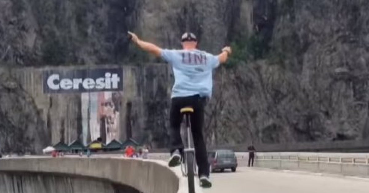Extreme Unicyclist Flaviu Cernescu Unicycles Across Dam In Romania For