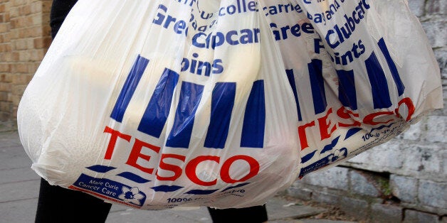 Tesco shopping bags are carried in London, Tuesday, April 21, 2009. Tesco PLC, Britain's largest retailer has reported full-year profits rose 2 percent to 2.17 billion pounds (US$3.15 billion) despite higher than expected losses on its fledgling U.S. venture. (AP Photo/Kirsty Wigglesworth)