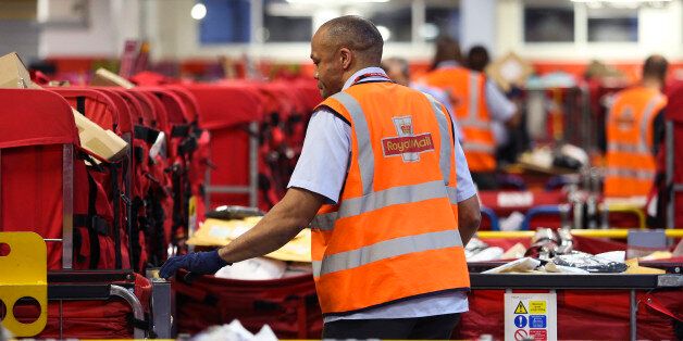 A Royal Mail Plc employee sorts parcels into red delivery destination trolleys at the company's Mount Pleasant postal sorting office in London, U.K., on Tuesday, Feb. 11, 2014. Royal Mail, the U.K. postal service that sold shares in an initial public offering last year, said like-for-like sales gained 2 percent in the first nine months of the year boosted by parcel deliveries. Photographer: Chris Ratcliffe/Bloomberg via Getty Images