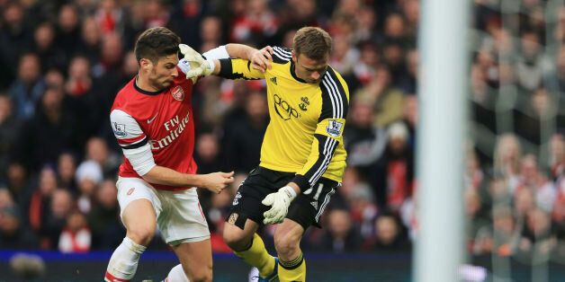 Arsenal's Olivier Giroud (left) challeges Southampton's Artur Boruc to then go on and score during the Barclays Premier League match at Emirates Stadium, London.