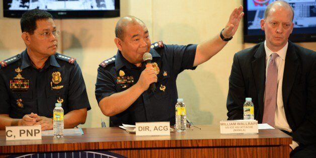 Gilbert Sosa (C), Philippine police chief of cyber crime division