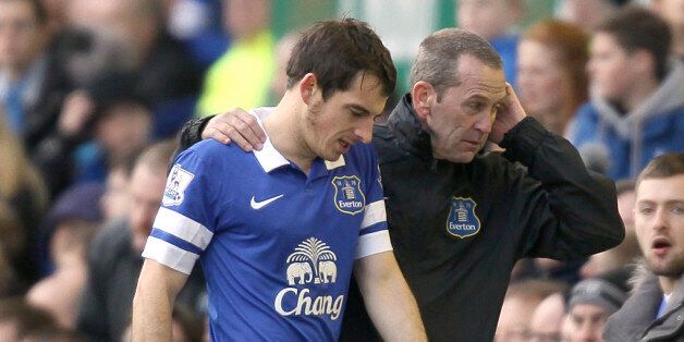 Everton's Leighton Baines is helped from the field of play after suffering an injury