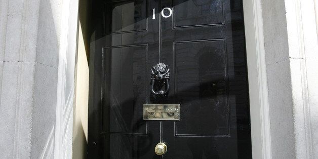 The door is opened at 10 Downing Street in Westminster, London.
