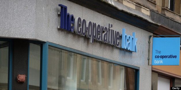 Members of the public walk past a co-operative bank in Glasgow, Scotland