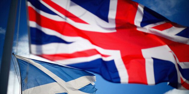 GLEN COE, SCOTLAND - MARCH 24: A Union Jack and Saltire flags blow in the wind near to Glen Coe on March 24, 2014 in Glen Coe, Scotland. A referendum on whether Scotland should be an independent country will take place on September 18, 2014. (Photo by Jeff J Mitchell/Getty Images)