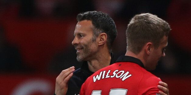 MANCHESTER, ENGLAND - MAY 06: Interim Manager Ryan Giggs of Manchester United congratulates James Wilson during the Barclays Premier League match between Manchester United and Hull City at Old Trafford on May 6, 2014 in Manchester, England. (Photo by John Peters/Man Utd via Getty Images)