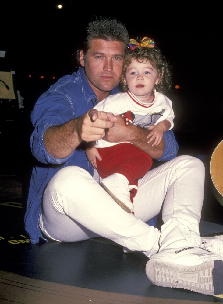With her dad Billy Ray Cyrus, 1994