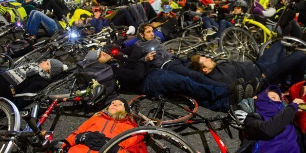 Cyclists take part in a 'die-in' protest outside the headquarters of Transport for London