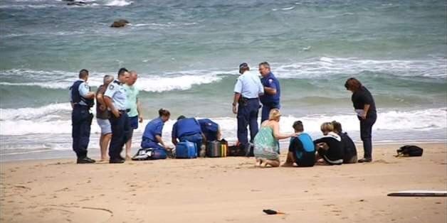 Paramedics assist the teenager after the shark attack
