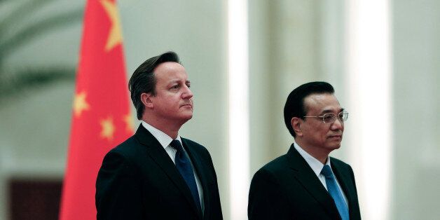 BEIJING, CHINA - DECEMBER 02: Chinese Premier Li Keqiang (R) invites British Prime Minister David Cameron (L) to view an honour guard during a welcoming ceremony inside the Great Hall of the People on December 2, 2013 in Beijing, China. At the invitation of Chinese Premier Li Keqiang, British Prime Minister David Cameron will pay an official visit to China from December 2 to 4. (Photo by Lintao Zhang/Getty Images)