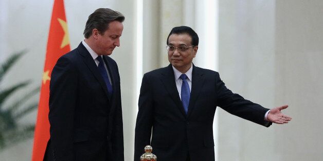 BEIJING, CHINA - DECEMBER 02: Chinese Premier Li Keqiang (R) invites British Prime Minister David Cameron (L) to view an honour guard during a welcoming ceremony inside the Great Hall of the People on December 2, 2013 in Beijing, China. At the invitation of Chinese Premier Li Keqiang, British Prime Minister David Cameron will pay an official visit to China from December 2 to 4. (Photo by Feng Li/Getty Images)