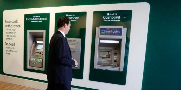 LONDON, ENGLAND - JUNE 19: Britain's Chancellor of the Exchequer George Osborne withdraws money from a cash machine during a visit to a branch of LloydsTSB bank on June 19, 2013 in London, England. The Chancellor, is expected to outline the government's plans for the future of banks Lloyds and Royal Bank of Scotland during a speech at the Lord Mayor's Bankers and Merchants Dinner at Mansion House later. (Luke MacGregor - WPA Pool/Getty Images)