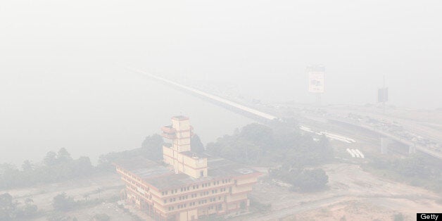 Haze covers the JohorSingapore Causeway in Johor Bahru, southern Malaysia on June 20, 2013 as acrid odour of burnt wood and grass could be smelled in living rooms and bedrooms across Singapore as well as inside the air-conditioned trains of Singapore's metro system. Malaysia was shrouded with smoky haze attributed to mainly fires burning on the Indonesian island of Sumatra causing 'unhealthy' levels of pollution in six areas.