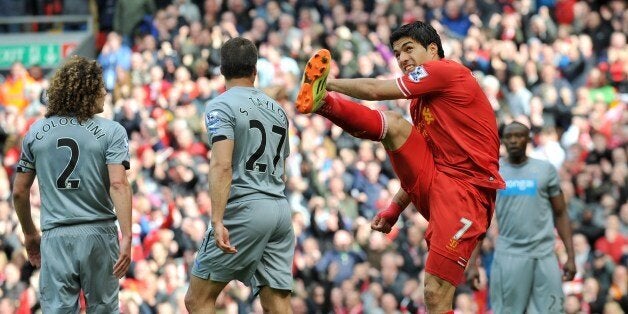 Liverpool's Uruguayan striker Luis Suarez (2nd R) celebrates his team's second goal after Liverpool's English striker Daniel Sturridge (not pictured) scored during the English Premier League football match between Liverpool and Newcastle United at Anfield stadium in Liverpool on May 11, 2014. AFP PHOTO/PAUL ELLIS - RESTRICTED TO EDITORIAL USE. No use with unauthorized audio, video, data, fixture lists, club/league logos or live services. Online in-match use limited to 45 images, no video emulat