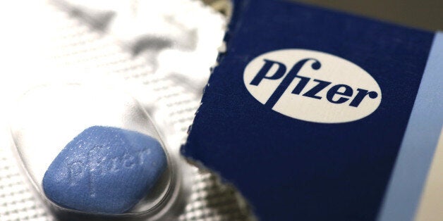 The Pfizer Inc. company logo is seen on packaging for Viagra tablets, produced by Pfizer Inc., in this arranged photograph taken in London, U.K., on Friday, May 2, 2014. AstraZeneca Plc rejected Pfizer Inc.'s sweetened takeover proposal, saying the 63.1 billion-pound ($106.5 billion) offer fails to recognize the value of the promising experimental medicines under development by the U.K.'s second-biggest drugmaker. Photographer: Chris Ratcliffe/Bloomberg via Getty Images