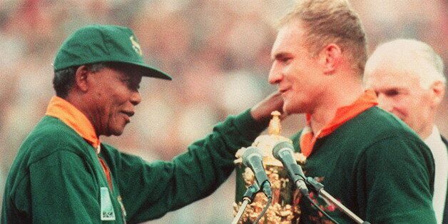 South Africa captain François Pienaar receives the Webb Ellis trophy from Mandela in 1995