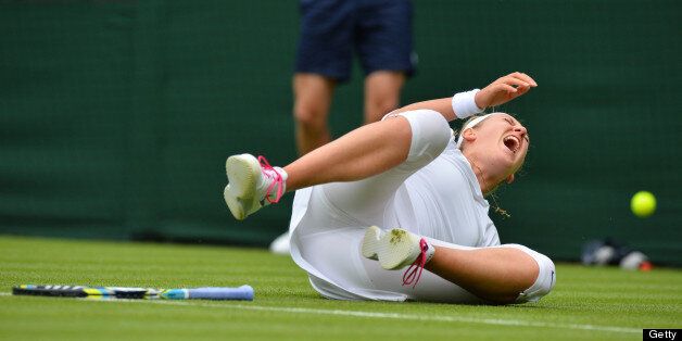Belarus's Victoria Azarenka falls on court during a point against Portugal's Maria Joao Kohler during their women's first round match on day one of the 2013 Wimbledon Championships tennis tournament at the All England Club in Wimbledon, southwest London, on June 24, 2013. AFP PHOTO / BEN STANSALL - RESTRICTED TO EDITORIAL USE (Photo credit should read BEN STANSALL/AFP/Getty Images)
