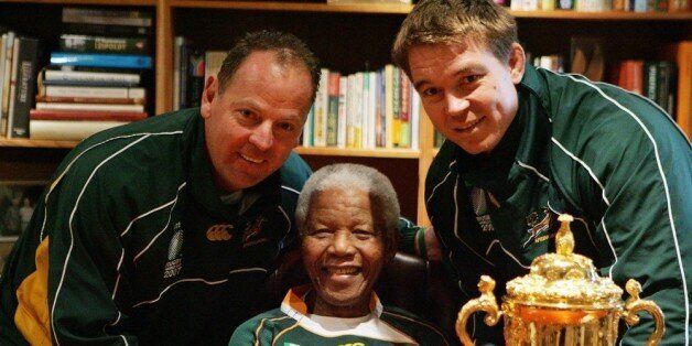 JOHANNESBURG, SOUTH AFRICA - 27: Former South Africa President Nelson Mandela poses with South Africa Rugby Union coach Jake White (L), South Africa Rugby Union captain John Smit (R) and the Webb-Ellis cup during the Springboks visit to Nelson Mandela at his residence on October 27, 2007 in Houghton, Johannesburg, South Africa. South Africa became the current holders of the cup after defeating Former champions England 15-6 in the 2007 Rugby World Cup Final. (Photo by Lefty Shivambu/Gallo Images/Getty Images)