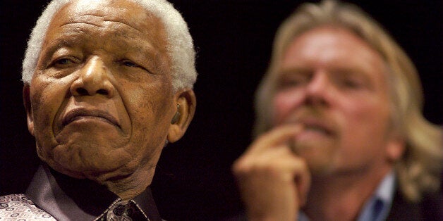 SOUTH AFRICA - JULY 18: Former South African President Nelson Mandela, left, and U.K. billionaire Richard Branson listen to Peter Gabriel sing 'Biko,' in Johannesburg, South Africa, on Wednesday, July 18, 2007. Mandela, South Africa's first black president and a Nobel peace prize winner, today announced the formation of a global think-tank of world leaders called The Elders. He used his 89th birthday today to launch the group. (Photo by Greg Marinovich/Bloomberg via Getty Images)