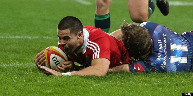 Sean Maitland of the Lions dives over for the Lions second try despite the attention of Lachlan Mitchell