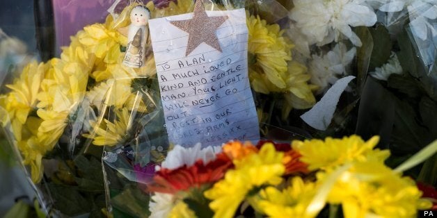 Flowers left at the scene near St Saviour in High Green, Sheffield where Alan Greaves was attacked while on his way to a Christmas Eve midnight mass.