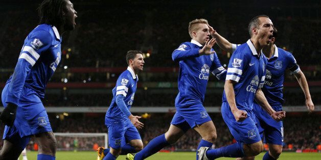 Everton players celebrate after Everton's Spanish striker Gerard Deulofeu (C) scored an equaliser during the English Premier League football match between Arsenal and Everton at The Emirates Stadium in north London on December 8, 2013. The match ended in a 1-1 draw. AFP PHOTO/ADRIAN DENNIS== RESTRICTED TO EDITORIAL USE. NO USE WITH UNAUTHORIZED AUDIO, VIDEO, DATA, FIXTURE LISTS, CLUB/LEAGUE LOGOS OR LIVE SERVICES. ONLINE IN-MATCH USE LIMITED TO 45 IMAGES, NO VIDEO EMULATION. NO USE IN BETTING, GAMES OR SINGLE CLUB/LEAGUE/PLAYER PUBLICATIONS == (Photo credit should read ADRIAN DENNIS/AFP/Getty Images)