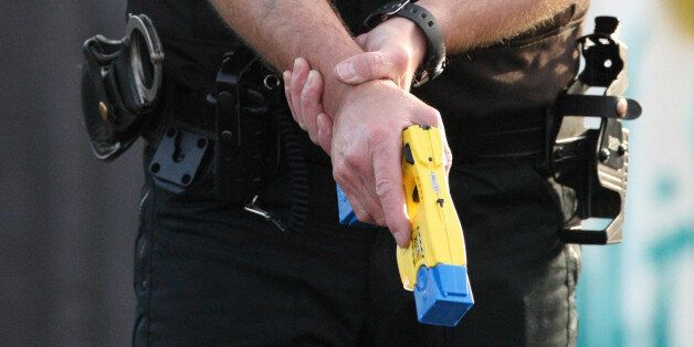 PC Terry Allan holds a Taser stun gun during at at the Police Headquarters in Ponteland, England.
