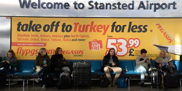 Passengers wait at Stansted Airport, Essex, after a