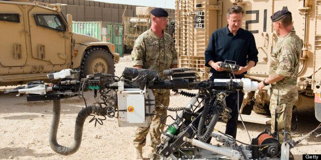 CAMP BASTION, AFGHANISTAN - JUNE 29: British Prime Minister David Cameron (C) is shown a remote-controlled IED detection unit used in regional operations during a visit to Camp Bastion on June 29, 2013 near Lashkar Gah, in the southern Helmand province, Afghanistan. Cameron made an unannounced visit to Afghanistan visiting troops in Helmand as the NATO military coalition hands responsibility over to local forces. (Photo by Leon Neal - WPA Pool/Getty Images)