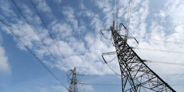 Power transmission lines run from electricity pylons in Braintree, U.K., on Wedenesday, Sept. 25, 2013. Britain's business lobby groups said that Labour leader Ed Miliband opposition's proposal to break up the 'Big Six' utilities and cap power prices threatens the investment needed to avoid blackouts by the end of the decade. Photographer: Chris Ratcliffe/Bloomberg via Getty Images