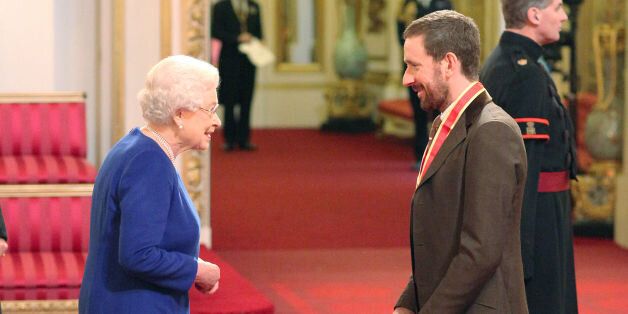 Sir Bradley Wiggins is knighted by Queen Elizabeth II at Buckingham Palace, central London.