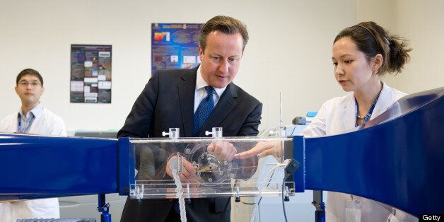 British Prime Minister David Cameron (C) is shown items of engineering equipment in a laboratory at Nazarbayev University ahead of a PM Direct event in Kazakhstan on July 1, 2013. Cameron flew to Kazakhstan late June 30, as part of a trade mission, on the first ever trip to the country by a serving British prime minister. AFP PHOTO/LEON NEAL/POOL (Photo credit should read LEON NEAL/AFP/Getty Images)