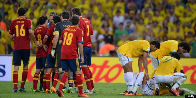 Gerard Pique of Spain (3) is sent off after a foul on Neymar of Brazil (grounded right) the FIFA Confederations Cup Brazil 2013 Final match between Brazil and Spain at Maracana