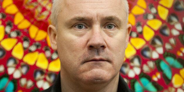 Artist Damien Hirst pictured in front of his work I Am Become Death, Shatterer of Worlds, on display at a retrospective exhibition of his work at the Tate Modern Gallery in London.