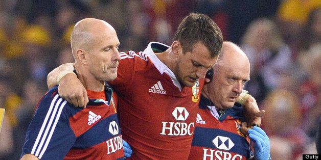 British and Irish Lions captain Sam Warburton (C) is helped off the field injured against the Australian Wallabies in the second rugby Test match, in Melbourne on June 29, 2013. AFP PHOTO/William WEST IMAGE RESTRICTED TO EDITORIAL USE - STRICTLY NO COMMERCIAL USE (Photo credit should read WILLIAM WEST/AFP/Getty Images)