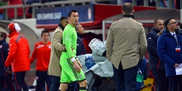 Anderlecht's goalkeeper Silvio Proto is given a red card from referee Wolfang Stark during an UEFA Champions League group C football match between Olympiakos and Anderlecht at the Karaiskaki stadium in Athens on December 10, 2013. AFP PHOTO / ARIS MESSINIS (Photo credit should read ARIS MESSINIS/AFP/Getty Images)