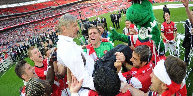 LONDON, ENGLAND - MAY 17: Thje Arsenal squad throw manager Arsene Wenger in the air after the FA Cup Final between Arsenal and Hull City at Wembley Stadium on May 17, 2014 in London, England. (Photo by Stuart MacFarlane/Arsenal FC via Getty Images)