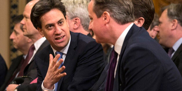 British opposition Labour Party leader, Ed Miliband (L) speaks with British Prime Minister, David Cameron (R) before listening to German Chancellor Angela Merkel's address to both Houses of Parliament in the Royal Gallery of the Palace of Westminster on February 27, 2014 in London. German Chancellor Angela Merkel urged Britain Thursday to stay in the EU but played down David Cameron's hopes that her visit to London would bring major reforms. The British premier rolled out the red carpet in his